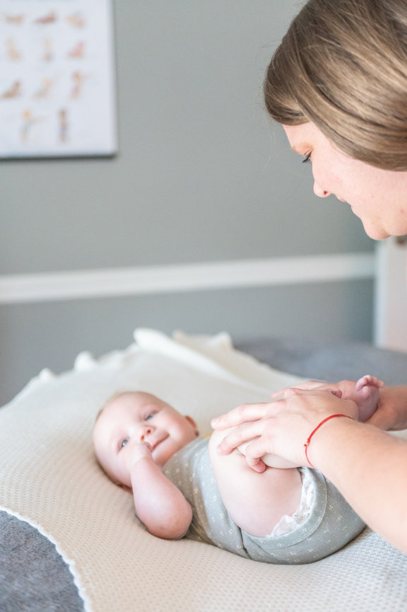 Deandra helping a baby move gas during an infant massage session.