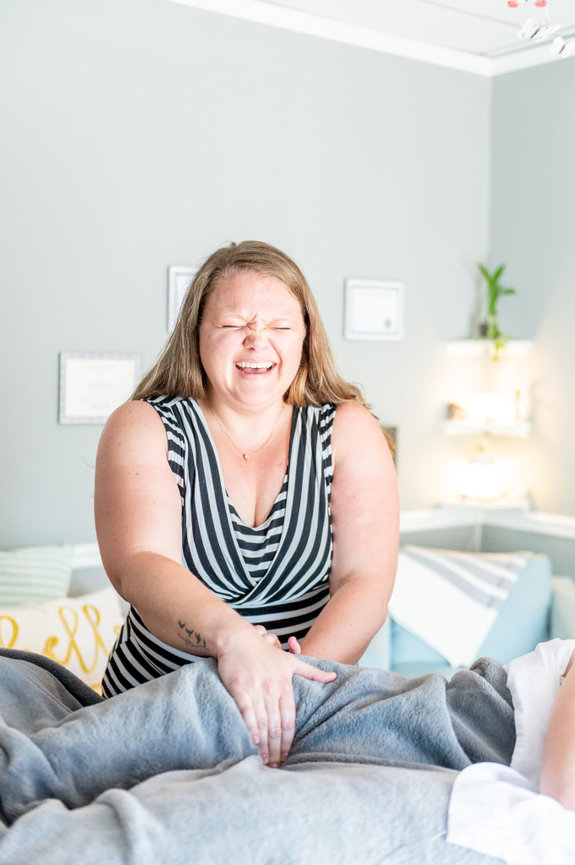 Deandra smiling while doing prenatal massage